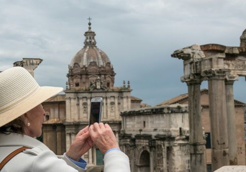 man in white long sleeve shirt holding smartphone